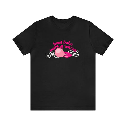 Front view of a black t shirt with a graphic design on it and a statement "boss babe making waves"